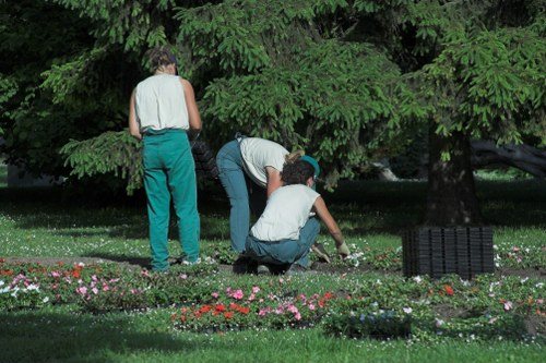 Workers placing safety signage in a public garden area